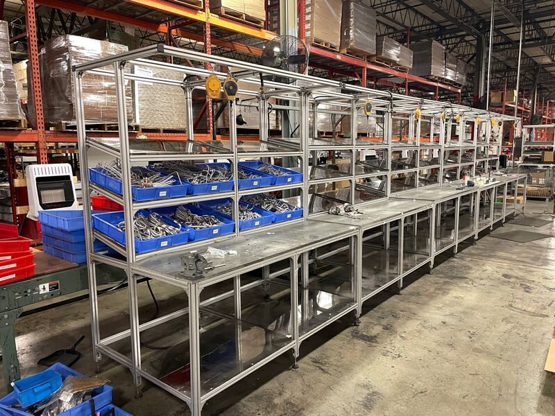 Bluegrass Living workstation after - organized aluminum extrusion workstation with labeled blue bins and spring balancers