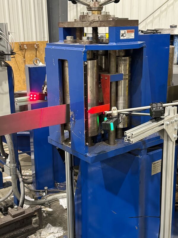Custom inline coil inspection system with Keyence laser sensors on tube forming press